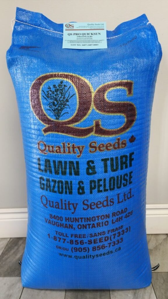 A large blue bag labeled "Quality Seeds" containing lawn and turf seeds, with a company address in Vaughan, Ontario, and contact information displayed.