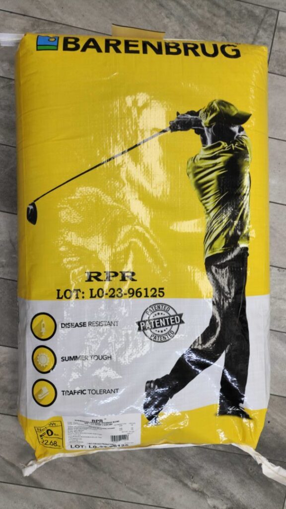 A yellow Barenbrug bag displaying a person playing golf, featuring labels for disease resistance, summer durability, and traffic tolerance.